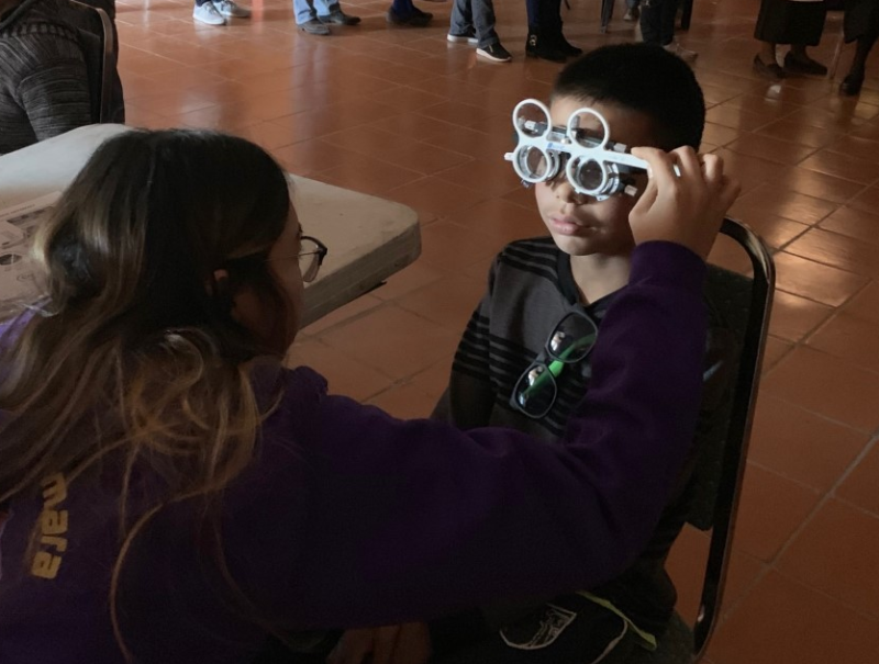 Young boy has eyes examined at free clinic